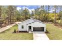 New construction one-story home with tidy lawn and paved driveway at 12380 Sw 71St Lane Rd, Ocala, FL 34481