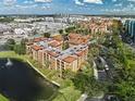 An aerial view of the condos, pool, landscaping and surrounding community at 12527 Floridays Resort Dr # 401E, Orlando, FL 32821