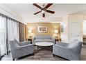 Cozy living room with ceiling fan, comfortable seating, and neutral decor at 12527 Floridays Resort Dr # 401E, Orlando, FL 32821