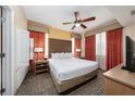 Comfortable main bedroom with king-size bed, ceiling fan, and warm lighting at 12527 Floridays Resort Dr # 401E, Orlando, FL 32821
