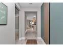 Modern entryway with wood-look flooring and unique wall accents leading into a brightly lit home interior at 12639 Sw 78Th Pl, Dunnellon, FL 34432