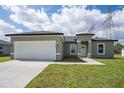 Attractive one-story home featuring a neat lawn, a two-car garage, and a welcoming front entrance at 17052 Sw 44Th Cir, Ocala, FL 34473
