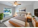 Modern bedroom with a soft color palette, a plush rug, and a ceiling fan, creating a cozy atmosphere at 1817 Christina Lee Ln, St Cloud, FL 34769