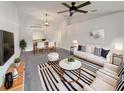 Bright living room boasts a modern design with striped accents and an open floor plan to the dining area at 1817 Christina Lee Ln, St Cloud, FL 34769