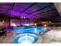 Enclosed pool area features a cascading waterfall, fire bowls, and a relaxing seating area at 19313 Pummelo Dr, Orlando, FL 32827
