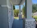 Covered front porch highlighting stone-clad columns and a peaceful outdoor space at 2005 Canton Park Dr, Winter Haven, FL 33881