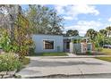 Single-story home featuring a well-manicured lawn, mature trees, and a covered entryway for added curb appeal at 2539 Antilles Dr, Winter Park, FL 32792