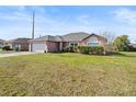 Inviting single-Gathering home with a lush green lawn, a two-car garage, and lovely landscaping at 2540 Courtland Blvd, Deltona, FL 32738