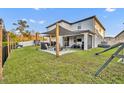 Well-maintained backyard featuring a covered patio, green lawn, and fenced perimeter at 2940 Scarlett Dr, St Cloud, FL 34772