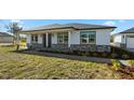 The home's charming exterior features stone accents, a covered porch and updated windows at 31905 Larkspur Ave, Eustis, FL 32736
