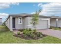 Charming one-story home with a two-car garage, brick driveway, and beautiful landscaping at 3876 Giorgio Dr, Winter Haven, FL 33884
