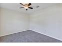 Neutral bedroom featuring new carpet, a ceiling fan, and ample natural light at 39 Hickory Course Way, Ocala, FL 34472