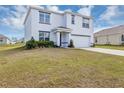 Beautiful two-story home with a well-maintained lawn, attached garage, and covered entry at 39 Hickory Course Way, Ocala, FL 34472