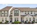 Two-story townhome featuring well-kept landscaping and a modern architectural style at 394 Captiva Dr, Davenport, FL 33896