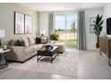 Inviting living room with a comfortable sectional sofa, stylish coffee table, and large windows with natural light at 4969 Kaia Ave, Winter Haven, FL 33884