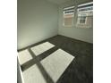 Cozy bedroom with soft carpeting, neutral walls, and sun-filled windows at 5221 Kildare Pl, St Cloud, FL 34771