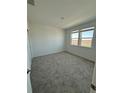 Bright, carpeted bedroom with ample natural light through two large windows at 5221 Kildare Pl, St Cloud, FL 34771