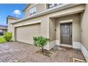 Charming front exterior with a two-car garage and a well-maintained, light-colored brick driveway and walkway at 638 Ogelthorpe Dr, Davenport, FL 33897