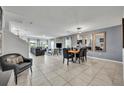 Bright living room featuring tile floors, staircase, modern furniture, and natural light from large windows at 638 Ogelthorpe Dr, Davenport, FL 33897