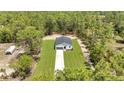 Areal view shows a new construction home on a spacious lot, backing up to Florida wilderness at 7007 Sw 131St Ave, Ocala, FL 34481