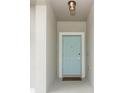 Close up of the home's light blue front door with white trim and a 'Home Sweet Home' doormat at 701 Bonsai St, Apopka, FL 32703