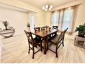 Inviting dining room featuring a wood table set next to a window with sheer curtains at 760 Annabell Ridge Rd, Minneola, FL 34715