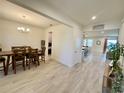 Spacious dining room with wood table set and chandelier, seamlessly connecting to the kitchen and living area at 760 Annabell Ridge Rd, Minneola, FL 34715