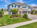 Charming two-story home with a well-kept lawn, landscaped garden, and convenient three-car garage at 760 Annabell Ridge Rd, Minneola, FL 34715