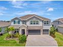 Beautiful two-story home with a three-car garage, stone accents, and well-manicured landscaping at 760 Annabell Ridge Rd, Minneola, FL 34715