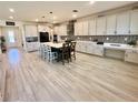 Bright kitchen features an oversized island with seating, modern appliances, and stunning backsplash at 760 Annabell Ridge Rd, Minneola, FL 34715