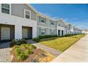 Attractive townhome exteriors with well-maintained landscaping and inviting walkways to each unit at 926 Paradise Dr, Davenport, FL 33897