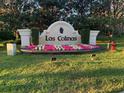 Elegant Las Colinas community entrance sign with decorative landscaping and manicured lawn at 9346 San Jose Blvd, Howey In The Hills, FL 34737