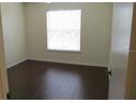 A well-lit bedroom with wood-look flooring and a large window at 1083 S Hiawassee Rd # 635, Orlando, FL 32835