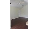 Bright living room featuring dark wood flooring, ceiling fan, and white trim at 1083 S Hiawassee Rd # 635, Orlando, FL 32835