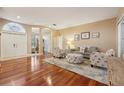 Spacious living area with hardwood floors, beach-themed furniture, and abundant natural light at 1232 Scandia Ter, Oviedo, FL 32765