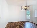 Bright living area featuring hardwood floors and a modern light fixture at 124 Meridian Ave, Kissimmee, FL 34759
