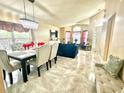 Open-concept living and dining area filled with natural light, featuring tile floors at 13440 Fordwell Dr, Orlando, FL 32828