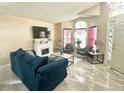 Bright living room featuring tile floors, a fireplace, and lots of natural light at 13440 Fordwell Dr, Orlando, FL 32828