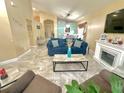 Spacious living room featuring tile floors, a fireplace, and an open-concept layout at 13440 Fordwell Dr, Orlando, FL 32828