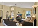 Bright living room featuring tile flooring, a high ceiling, and sliding glass doors leading to the pool area at 151 Castaway Beach Way, Kissimmee, FL 34746