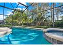 Enjoy this beautiful screened-in pool and spa, perfect for outdoor relaxation and entertaining guests at 151 Castaway Beach Way, Kissimmee, FL 34746