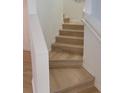 Staircase with light wood treads, white risers, and a matching handrail at 1552 Broken Oak Dr # B, Winter Garden, FL 34787