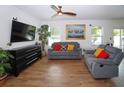 Comfortable living room featuring wood-look tile floors, a ceiling fan, and neutral paint at 1588 Diamond Loop Dr, Kissimmee, FL 34744
