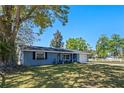 Charming single-story home with a well-manicured lawn, inviting front porch and a one car garage at 1815 6Th Se St, Winter Haven, FL 33880