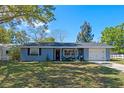 Well-maintained single-Gathering home with a lush green lawn and a cozy front porch under a clear blue sky at 1815 6Th Se St, Winter Haven, FL 33880