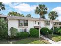 Exterior of a well-maintained condo building with palm trees and manicured landscaping at 200 Maitland Ave # 86, Altamonte Springs, FL 32701