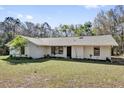 Classic single-story home with a well-manicured lawn and established trees at 20240 Sw 95Th St, Dunnellon, FL 34431