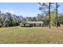 Sprawling property featuring a well-kept lawn and a single-story home at 20240 Sw 95Th St, Dunnellon, FL 34431