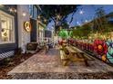 Outdoor patio featuring brick pavers, picnic tables, and a vibrant mural, great for entertaining at 301 S Palmetto Ave, Sanford, FL 32771