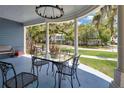 Inviting front porch with a table and chairs, perfect for relaxing and enjoying the neighborhood view at 301 S Palmetto Ave, Sanford, FL 32771